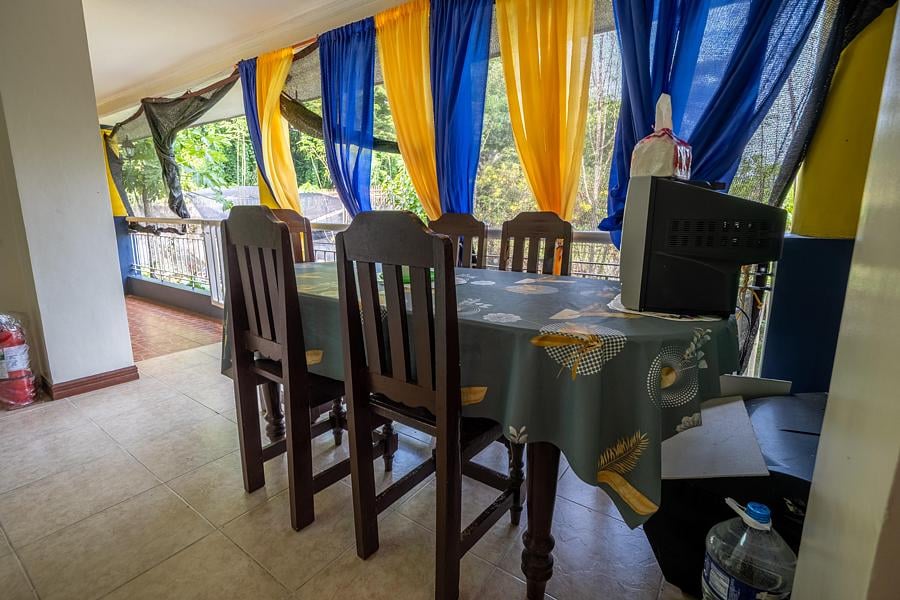 Dining table and chairs overlooking the greenery outside Pecan Pension House