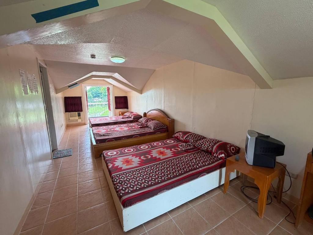 Family room with three beds for groups traveling together near Iloilo Airport